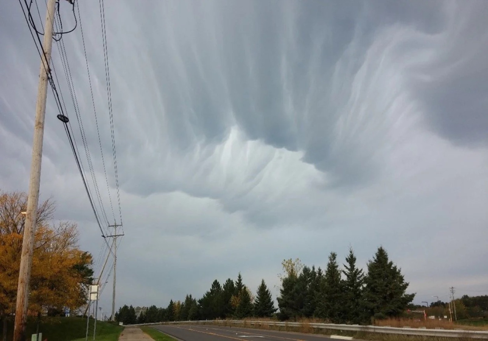 A sheared mammatus cloud, its pouch-like undersides lit by low sun, over Stillwater, Minnesota